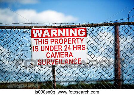 Stock Photography - Warning sign on fence. Fotosearch