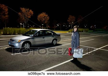 Stock Photograph - Woman alone in car park. Fotosearch
