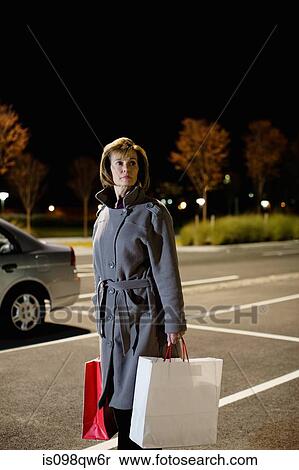 Stock Photography - Woman alone in parking lot. Fotosearch