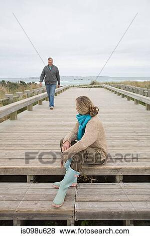 Woman and man on coastal walkway View Large Photo Image Stock Photo - Woman and man on coastal walkway. Fotosearch