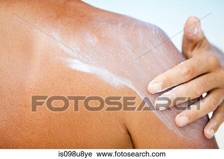 Stock Image - Woman applying sunscreen, Maldives. Fotosearch