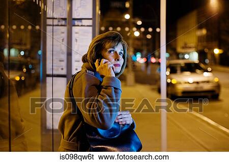 Woman at bus stop View Large Photo Image Stock Photograph - Woman at bus stop. Fotosearch