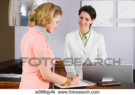 Woman at dental surgery reception View Large Photo Image Stock Image - Woman at dental surgery reception. Fotosearch