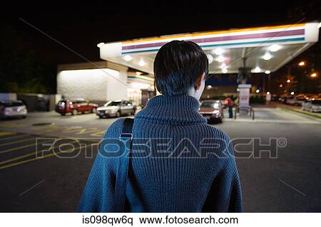 Stock Photography - Woman at gas station. Fotosearch