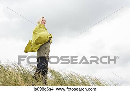Woman at the coast in blanket View Large Photo Image Picture - Woman at the coast in blanket. Fotosearch
