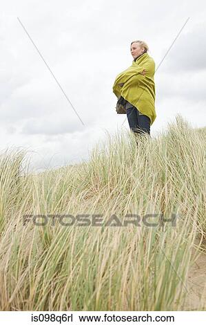 Woman at the coast in blanket View Large Photo Image Stock Image - Woman at the coast in blanket. Fotosearch