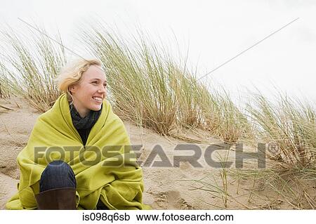 Woman at the coast in blanket View Large Photo Image Stock Image - Woman at the coast in blanket. Fotosearch