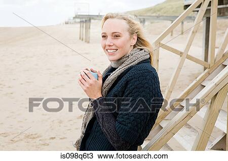 Stock Image - Woman at the coast. Fotosearch