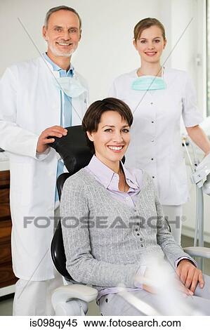 Woman at with dentist and hygienist View Large Photo Image Stock Photography - Woman at with dentist and hygienist. Fotosearch