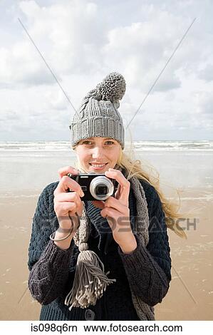 Woman by the sea with camera View Large Photo Image Picture - Woman by the sea with camera. Fotosearch