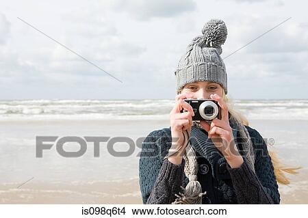 Woman by the sea with camera View Large Photo Image Picture - Woman by the sea with camera. Fotosearch