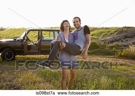 Woman carrying boyfriend View Large Photo Image Stock Image - Woman carrying boyfriend. Fotosearch