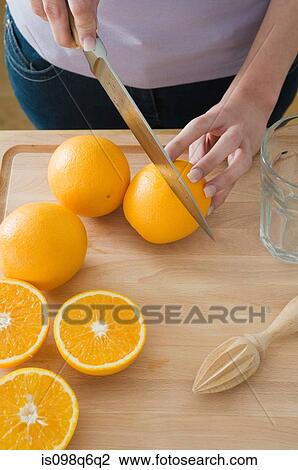 Woman cutting oranges View Large Photo Image Stock Image - Woman cutting oranges. Fotosearch