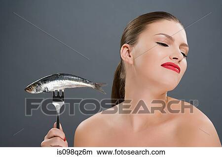 Woman disgusted at a fish View Large Photo Image Picture - Woman disgusted at a fish. Fotosearch