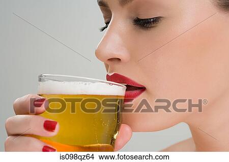 Woman drinking a pint of lager View Large Photo Image Picture - Woman drinking a pint of lager. Fotosearch