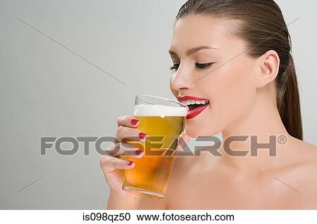 Woman drinking a pint of lager View Large Photo Image Stock Image - Woman drinking a pint of lager. Fotosearch