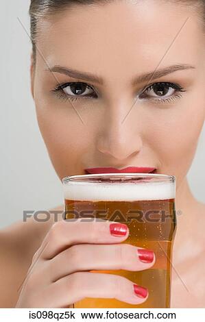 Woman drinking a pint of lager View Large Photo Image Stock Image - Woman drinking a pint of lager. Fotosearch