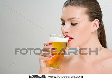 Woman drinking a pint of lager View Large Photo Image Stock Image - Woman drinking a pint of lager. Fotosearch