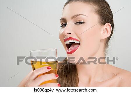 Woman drinking a pint of lager View Large Photo Image Stock Photo - Woman drinking a pint of lager. Fotosearch