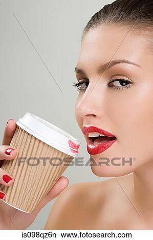 Woman drinking coffee from a paper cup View Large Photo Image Picture - Woman drinking coffee from a paper cup. Fotosearch