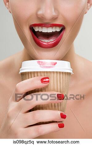 Woman drinking coffee from a paper cup View Large Photo Image Stock Photography - Woman drinking coffee from a paper cup. Fotosearch
