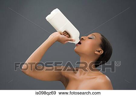 Woman drinking milk View Large Photo Image Stock Photo - Woman drinking milk. Fotosearch