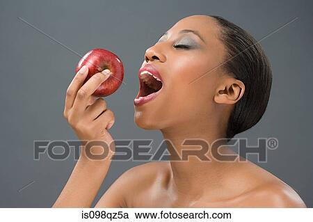 Woman eating an apple View Large Photo Image Stock Image - Woman eating an apple. Fotosearch