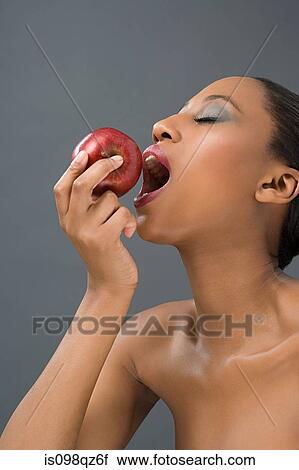 Stock Image - Woman eating an apple. Fotosearch