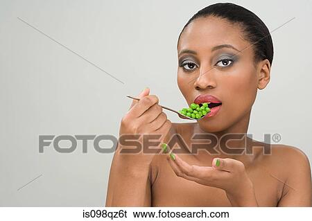 Woman eating peas View Large Photo Image Stock Photograph - Woman eating peas. Fotosearch