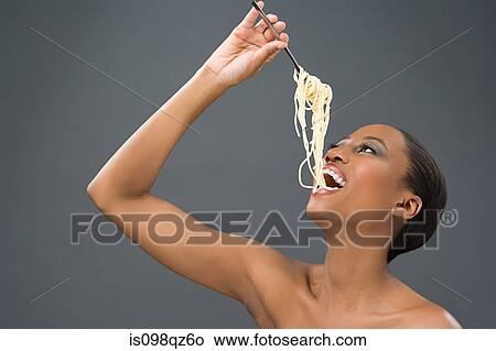 Picture - Woman eating spaghetti. Fotosearch