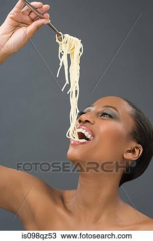 Stock Image - Woman eating spaghetti. Fotosearch
