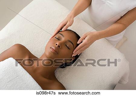 Woman having a head massage View Large Photo Image Stock Photograph - Woman having a head massage. Fotosearch