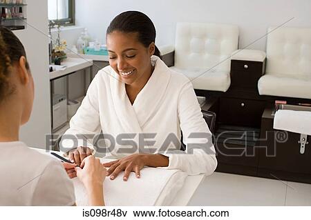 Stock Photo - Woman having a manicure. Fotosearch