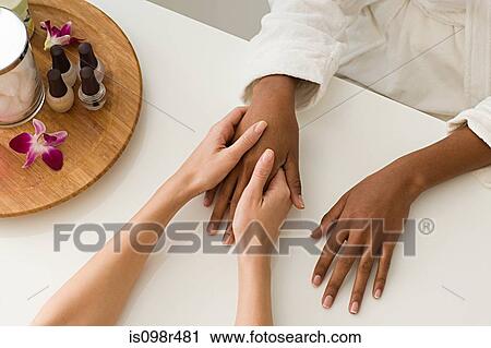 Stock Image - Woman having hands massaged. Fotosearch