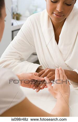 Stock Photo - Woman having hands massaged. Fotosearch