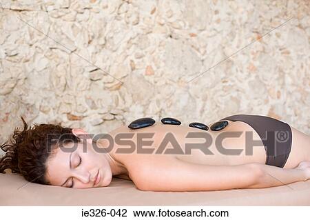 Stock Image - Woman having stone therapy. Fotosearch