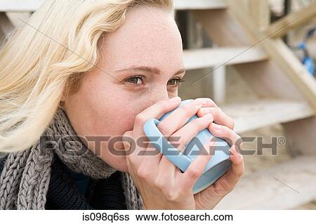 Stock Photograph - Woman having warm drink. Fotosearch
