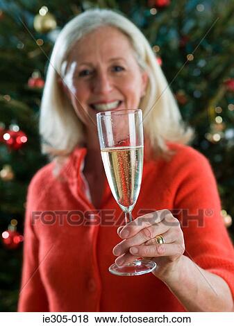 Woman holding a champagne flute View Large Photo Image Stock Photo - Woman holding a champagne flute. Fotosearch
