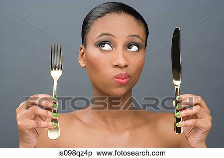 Woman holding a knife and fork View Large Photo Image Stock Photography - Woman holding a knife and fork. Fotosearch