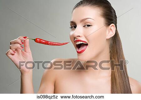 Woman holding a red chili pepper View Large Photo Image Stock Photo - Woman holding a red chili pepper. Fotosearch