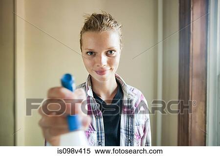 Woman holding cleaning fluid sprayer View Large Photo Image Stock Photography - Woman holding cleaning fluid sprayer. Fotosearch