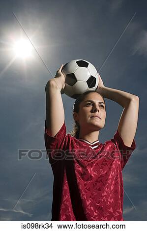 Picture - Woman holding football. Fotosearch