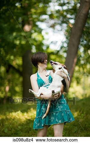 Woman holding her pet beagle View Large Photo Image Picture - Woman holding her pet beagle. Fotosearch