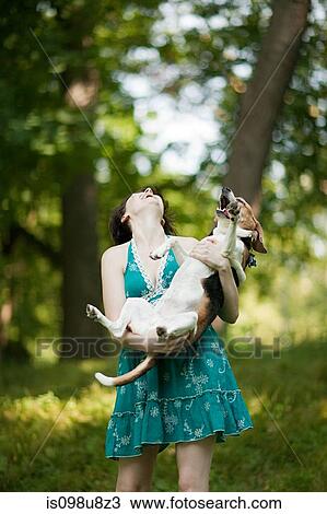 Woman holding her pet beagle View Large Photo Image Stock Image - Woman holding her pet beagle. Fotosearch