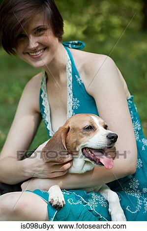 Woman holding her pet beagle View Large Photo Image Stock Photo - Woman holding her pet beagle. Fotosearch
