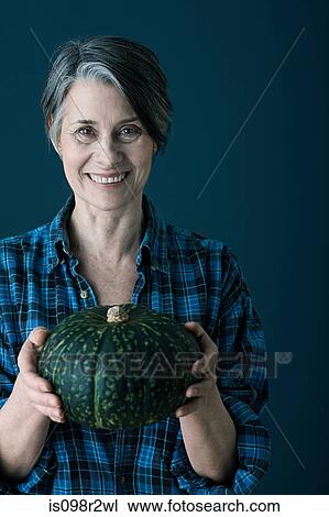 Woman holding pumpkin View Large Photo Image Stock Image - Woman holding pumpkin. Fotosearch