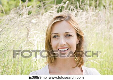 Woman in a field of grass View Large Photo Image Stock Photography - Woman in a field of grass. Fotosearch