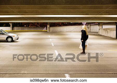 Woman in alone in parking lot View Large Photo Image Picture - Woman in alone in parking lot. Fotosearch