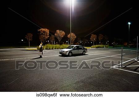 Woman in alone in parking lot View Large Photo Image Stock Image - Woman in alone in parking lot. Fotosearch
