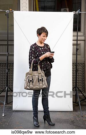 Stock Photo - Woman in front of backdrop. Fotosearch